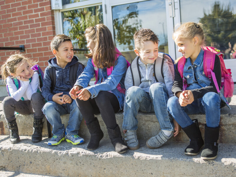 students outside school standing together